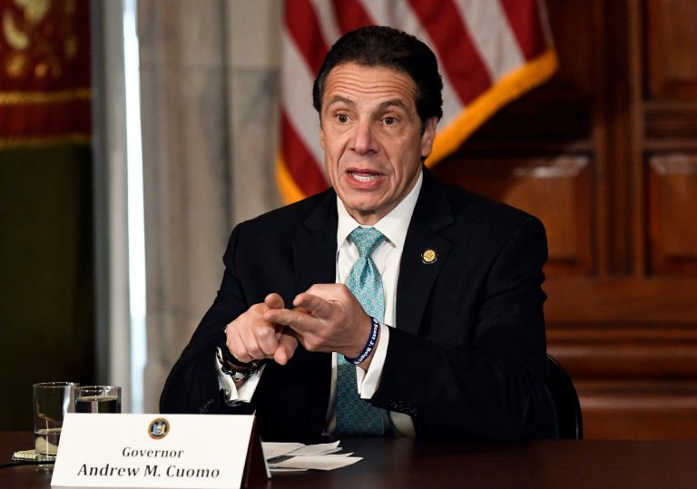 In this Tuesday,  Jan. 29, 2019 file photo, New York Gov. Andrew Cuomo meets with gun safety advocates in the Red Room during a news conference at the state Capitol in Albany, N.Y.  