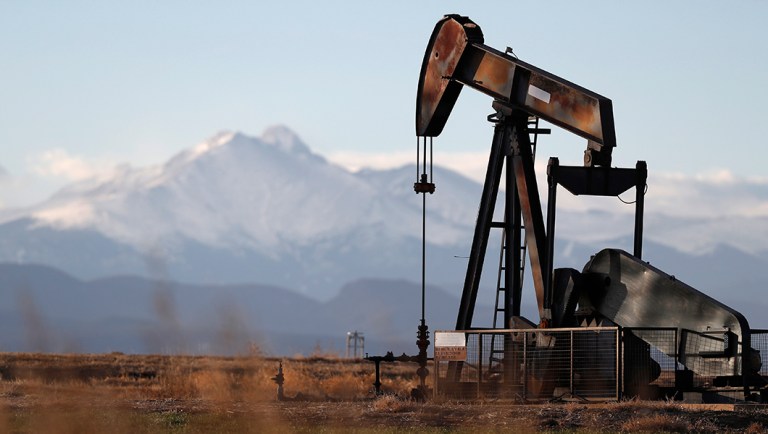 FILE - This Dec. 22, 2018, file photo shows a pump jack over an oil well along Interstate 25 near Dacono, Colo.
