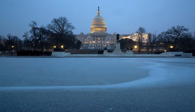 The Capitol is seen with the Reflecting Pool covered in ice and snow, in Washington, early Friday, Feb. 1, 2019. 