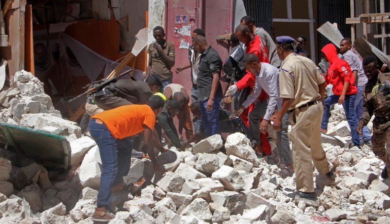 Rescuers search for people trapped under the rubble after a blast in the capital Mogadishu, Somalia Monday, Feb. 4, 2019. 