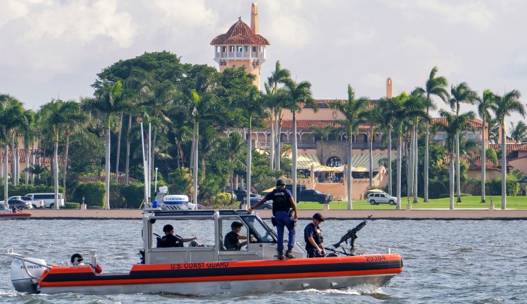 FILE - In this Nov. 22, 2018 photo, a U.S. Coast Guard patrol boat passes President Donald Trump's Mar-a-Lago estate in Palm Beach, Fla. A government watchdog says President Donald Trumpâs four trips to Mar-a-Lago in early 2017 cost taxpayers nearly $14 million. 