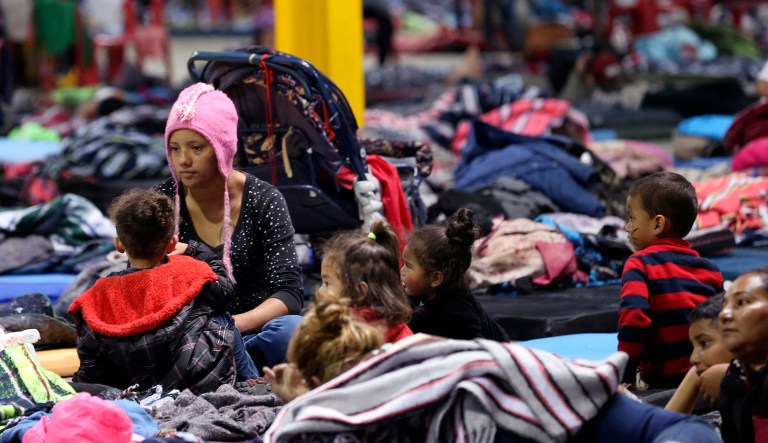 Delia Romero, a migrant from Honduras (pictured left), her children, and several others are pictured in a shelter in Piedras Negras, Mexico.