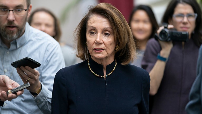 Speaker of the House Nancy Pelosi, D-Calif., walks with reporters.