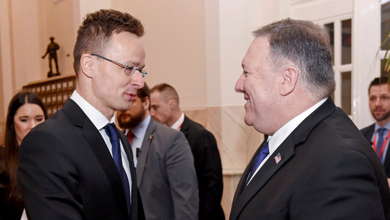 Secretary of State, Mike Pompeo, right, and Hungary's Minister of Foreign Affairs and Trade, Peter Szijjarto, left, shake hands in Budapest.