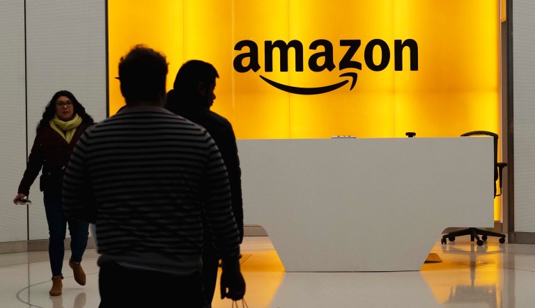 People walk into the lobby for Amazon offices in New York.