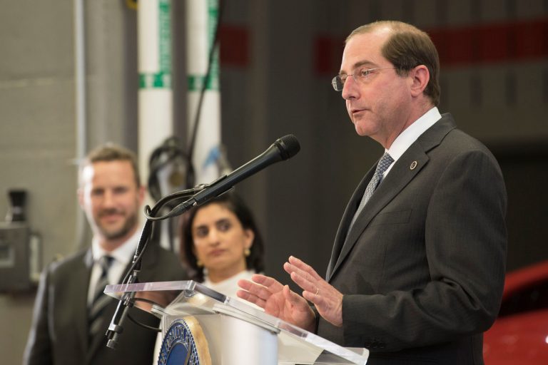 HHS Secretary Alex Azar, right, speak during a news conference.