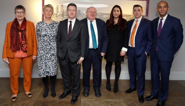 Seven MPs from left, Ann Coffey, Angela Smith, Chris Leslie, Mike Gapes, Luciana Berger, Gavin Shuker and Chuka Umunna, pose for a photograph after a press conference to announce the new political party, The Independent Group, in London, Monday, Feb. 18, 2019. 