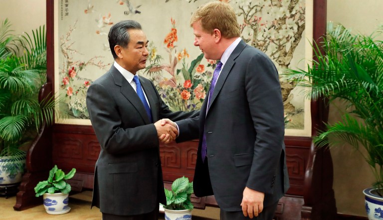 Chinese State Councilor and Foreign Minister Wang Yi, left, shakes hands with Myron Brilliant, executive vice president and head of International Affairs at the U.S. Chamber of Commerce ahead of a meeting at the Ministry of Foreign Affairs in Beijing Tuesday, Feb. 19, 2019.