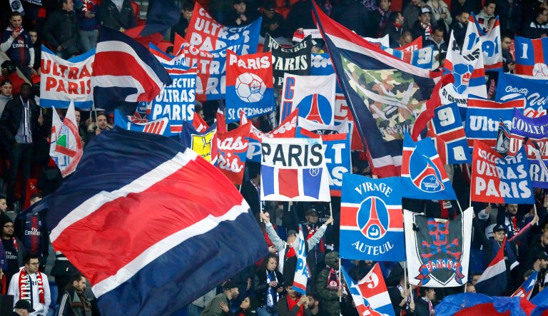 Paris Saint Germain's fans react with flags prior to the French League One soccer match between Paris Saint Germain and Montpellier at the Parc des Princes stadium in Paris, France, Wednesday, Feb. 20, 2019. 