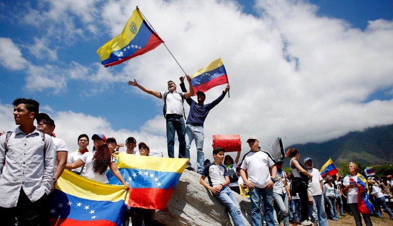 Opposition supporters converge in front of La Carlota military base urging soldiers to join their fight and allow the entry of U.S. humanitarian aid, in Caracas, Venezuela.
