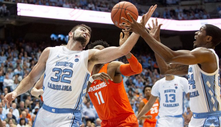 North Carolina's Luke Maye (32) and Kenny Williams (24), and Syracuse's Oshae Brissett (11) battle for a rebound during the first half of an NCAA college basketball game in Chapel Hill, N.C., Tuesday, Feb. 26, 2019. 