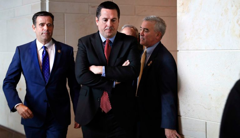 Rep. John Ratcliffe R-Texas, left, and House Intelligence Committee Ranking Member Devin Nunes, R-Calif., center, leave a closed-door meeting of the House Intelligence Committee with testimony from Michael Cohen, President Donald Trump's former personal lawyer, Monday, Feb. 5, 2018, to attend a vote on Capitol Hill in Washington. 