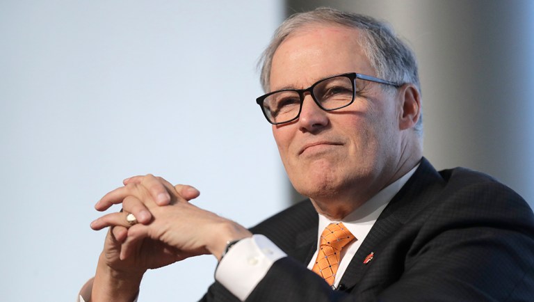 Washington Gov. Jay Inslee listens as he takes part in a nonpartisan panel discussion titled "Foreign Affairs and National Security in the Age of Climate Change" hosted by the University of Washington.