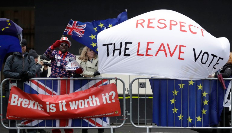 Pro-Brexit and anti-Brexit signs are seen in London.