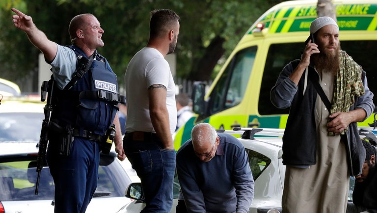 Police attempt to clear people from outside a mosque in central Christchurch, New Zealand.