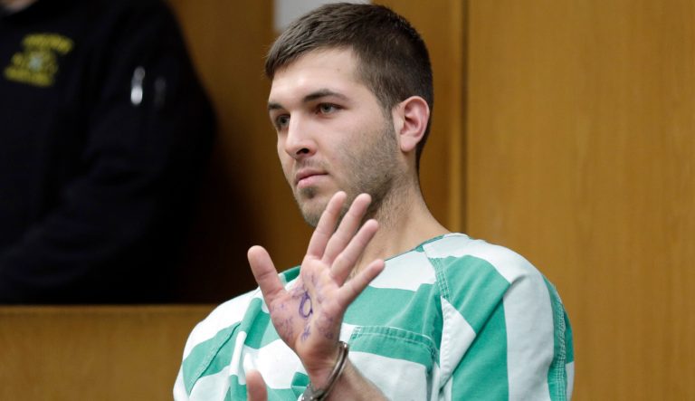 Anthony Comello displays writing on his hand during his extradition hearing in Toms River, N.J., Monday, March 18, 2019. 