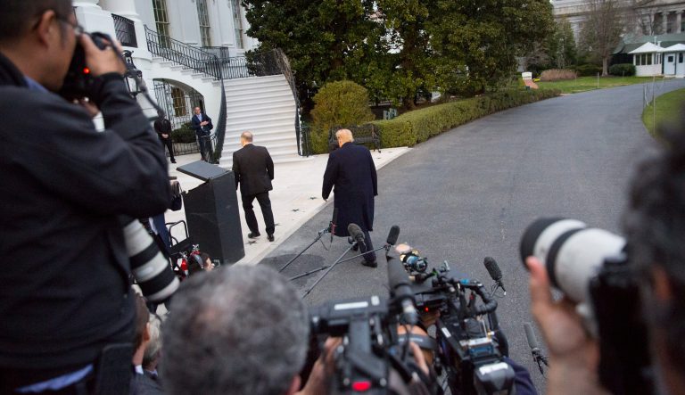 President Donald Trump, center, walks away after speaking to the media following his arrival on Marine One helicopter on the South Lawn of the White House, Sunday, March 24, 2019, in Washington. 