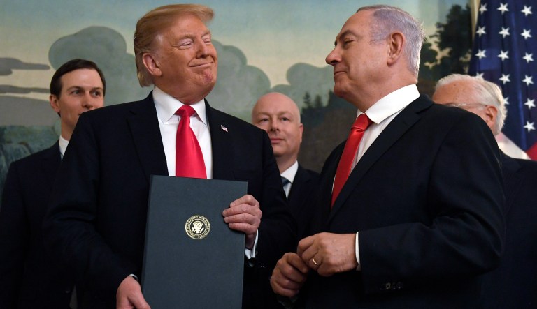 President Donald Trump smiles at Israeli Prime Minister Benjamin Netanyahu, right, after signing a proclamation in the Diplomatic Reception Room at the White House in Washington, Monday, March 25, 2019. Trump signed an official proclamation formally recognizing Israel's sovereignty over the Golan Heights.
