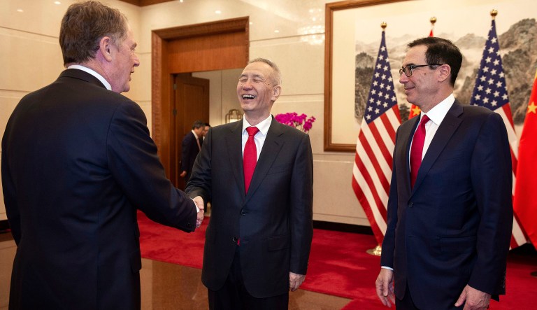 China's Vice Premier Liu He, center, shakes hands with U.S. Trade Representative Robert Lighthizer, watched by U.S. Treasury Secretary Steven Mnuchin, right, at Diaoyutai State Guesthouse in Beijing Friday, March 29, 2019.
