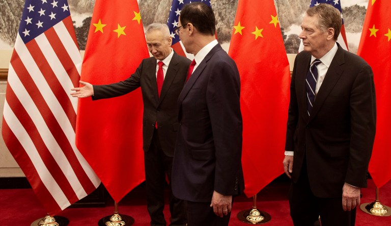 China's Vice Premier Liu He, left, gestures after he posed for a photo with U.S. Treasury Secretary Steven Mnuchin, center, and U.S. Trade Representative Robert Lighthizer at Diaoyutai State Guesthouse in Beijing Friday, March 29, 2019. 