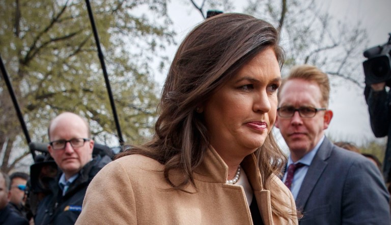 White House press secretary Sarah Sanders walks off after speaking with reporters outside the White House in D.C.
