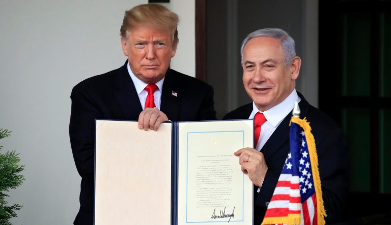 In this March 25, 2019 photo, Israeli Prime Minister Benjamin Netanyahu and President Donald Trump hold up the signed proclamation recognizing Israel's sovereignty over the Golan Heights at the White House in Washington.