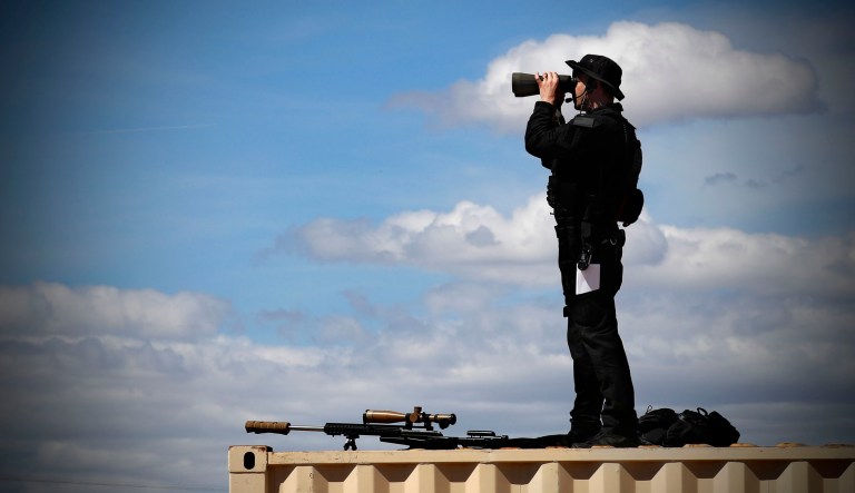 A member of the U.S. Secret Service's Counter Assault Team, known in the agency as CAT, surveys the area during a visit by President Trump to California.