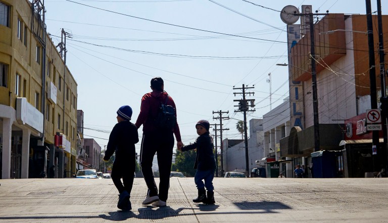 Ruth Aracely Monroy walks with her sons in Tijuana, Mexico. After requesting asylum in the United States, the family was returned to Tijuana to wait for their hearing in San Diego.