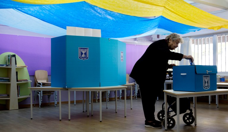 A woman votes during Israel's parliamentary election at a polling station.