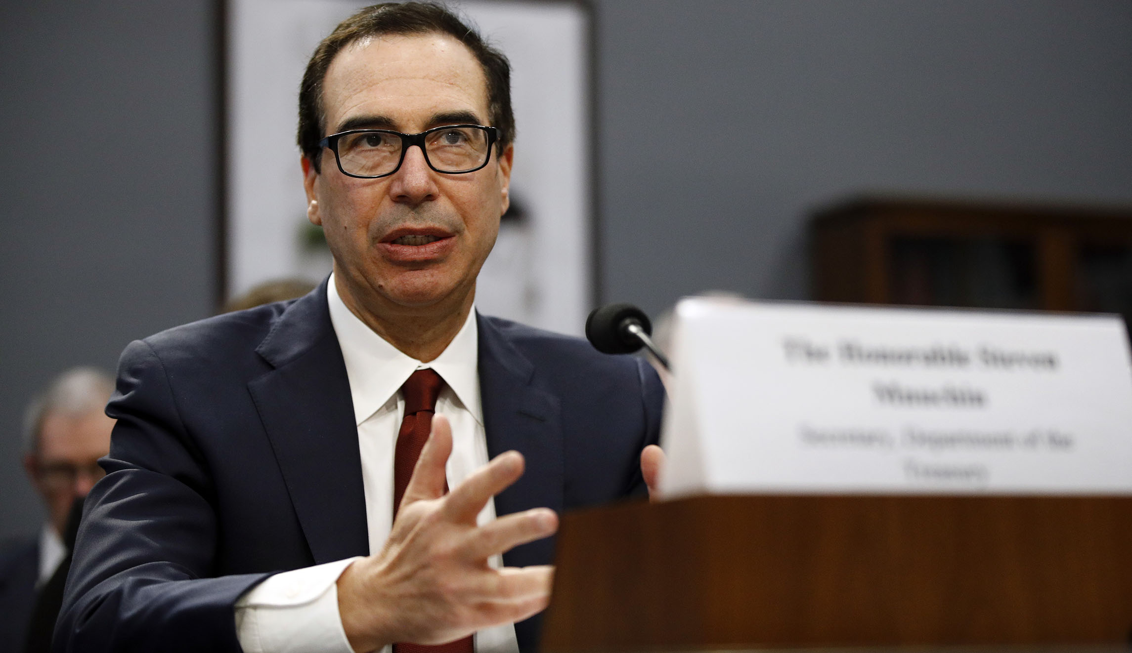 Mnuchin denies conflicts over Trump tax returns, Russian sanctions