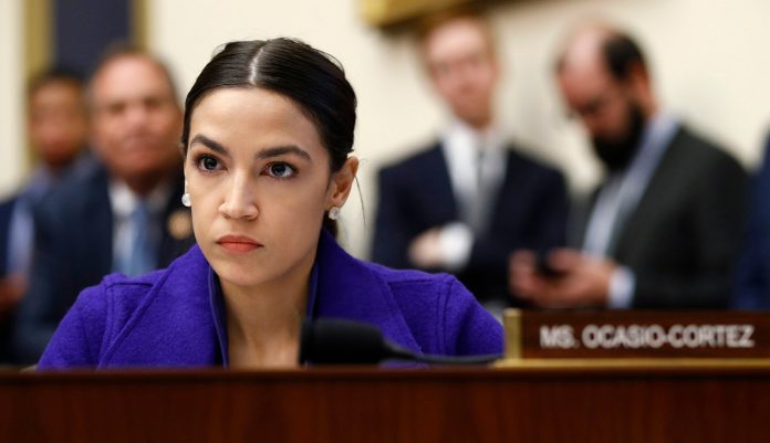 In this Wednesday, April 10, 2019 photo, Rep. Alexandria Ocasio-Cortez, D-N.Y., listens during a House Financial Services Committee hearing on Capitol Hill in Washington. 