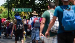 Migrants break Guatemalan border gate, force their way into Mexico
