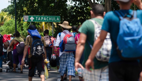 Migrants break Guatemalan border gate, force their way into Mexico