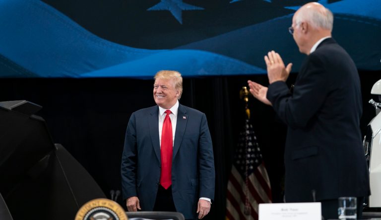 President Donald J. Trump walked out to an applause at Nuss Truck and Equipment in Burnsville for a roundtable discussion on tax cuts and the U.S. economy in Burnsville, Minn., on Monday, April 15, 2019. At right is the president of Nuss Truck and Equipment Bob Nuss. 