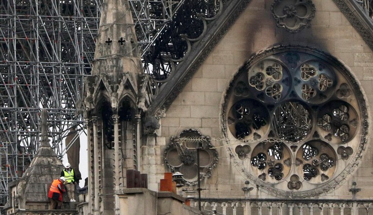 Experts inspect the damaged Notre Dame cathedral after the fire in Paris, Tuesday, April 16, 2019. Experts are assessing the blackened shell of Paris' iconic Notre Dame cathedral to establish next steps to save what remains after a devastating fire destroyed much of the almost 900-year-old building. With the fire that broke out Monday evening and quickly consumed the cathedral now under control, attention is turning to ensuring the structural integrity of the remaining building. 