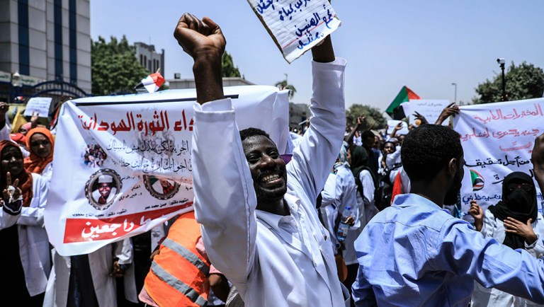 Sudanese demonstrators march at a rally outside the army headquarters.