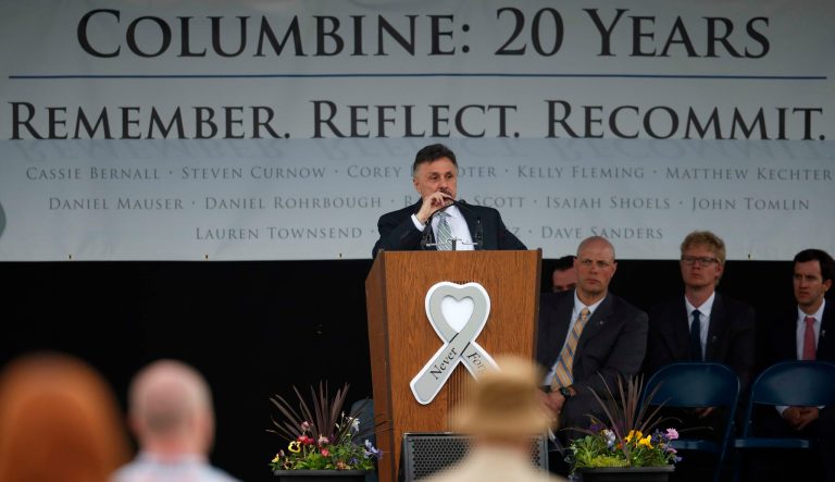 Frank DeAngelis, who was principal of Columbine High School during the attack 20 years ago, struggles through his remarks during a program for the victims of the massacre Saturday, April 20, 2019, in Littleton, Colo. 
