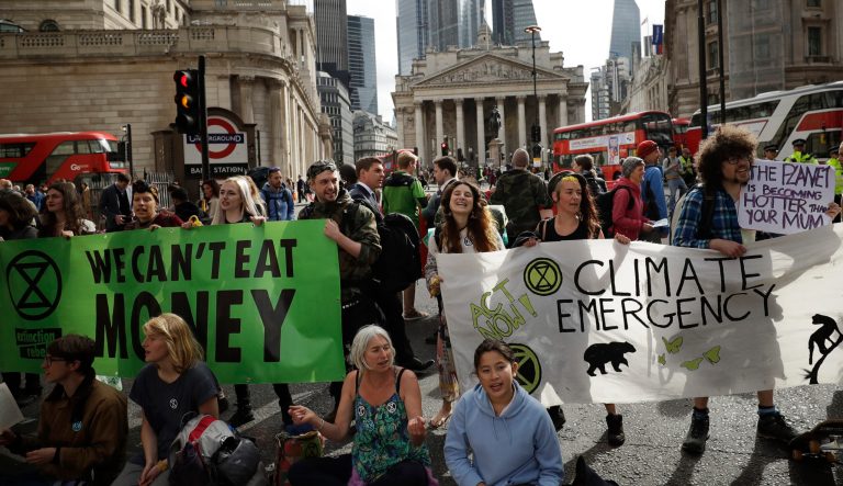 Extinction Rebellion climate change protesters block a road in central London, Thursday, April 25, 2019. The non-violent protest group, Extinction Rebellion, is seeking negotiations with the government on its demand to make slowing climate change a top priority. 