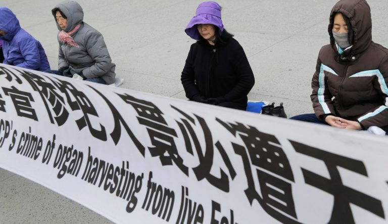 Practitioners of Falun Dafa, also called Falun Gong, meditate and exercise outside of the Chinese consulate, Thursday, April 25, 2019, in New York. 