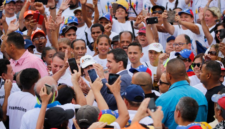 Venezuela's opposition leader and self proclaimed president Juan Guaido, center, greets the crowd during a rally in Caracas, Venezuela, Saturday, April 27, 2019.