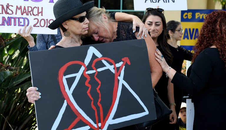 Leslie Gollub, left, and Gretchen Gordon hug at a vigil held to support the victims of the Chabad of Poway synagogue shooting, Sunday, April 28, 2019, in Poway, Calif. A man opened fire Saturday inside the synagogue near San Diego as worshippers celebrated the last day of a major Jewish holiday.