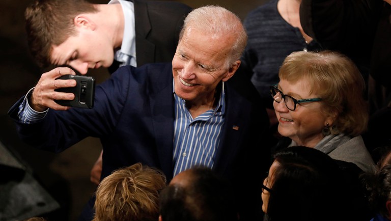 Former Vice President and Democratic presidential candidate Joe Biden poses for photos.