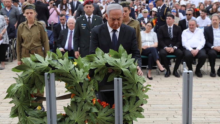 Israeli Prime Minister Benjamin Netanyahu lays a wreath during the opening ceremony of Israel's annual Holocaust Remembrance Day.