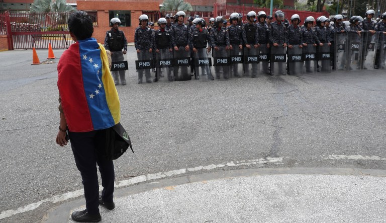 An opponent to Venezuela's President stands outside the Navy's command headquarter in Caracas, Venezuela, Saturday, May 4, 2019.