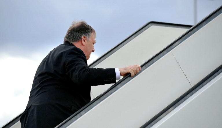 Secretary of State Mike Pompeo boards a plane.