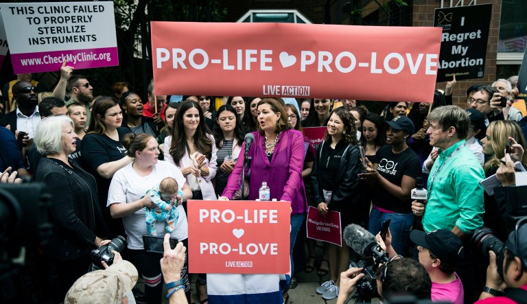 Ashley Garecht speaks as anti-abortion protesters rally near a Planned Parenthood clinic in Philadelphia, Friday, May 10, 2019. The demonstration was spurred by the actions of a Democratic state lawmaker who recorded himself berating an anti-abortion demonstrator at length outside the clinic.