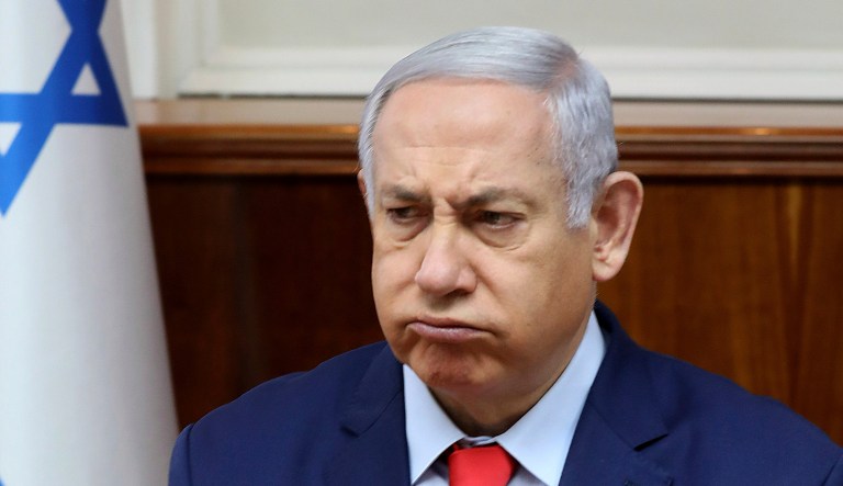 Israel's Prime Minister Benjamin Netanyahu reacts at the start of the weekly Cabinet meeting in Jerusalem.