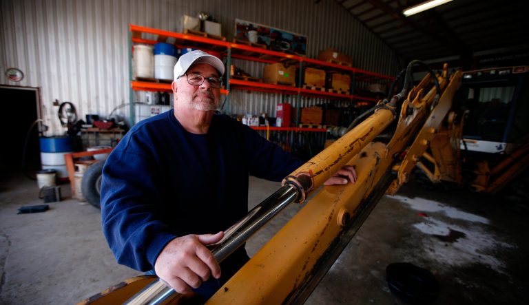 Bret Davis, a soybean farmer, poses with farm equipment in Delaware, Ohio, on Tuesday, May 14, 2019. Some farmers fear the protracted trade war with China will permanently alter their sales, leaving them without a foothold in one of their largest markets. 