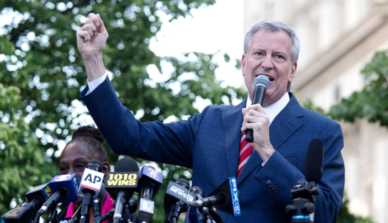 Democratic presidential candidate New York Mayor Bill de Blasio speaks during a protest.