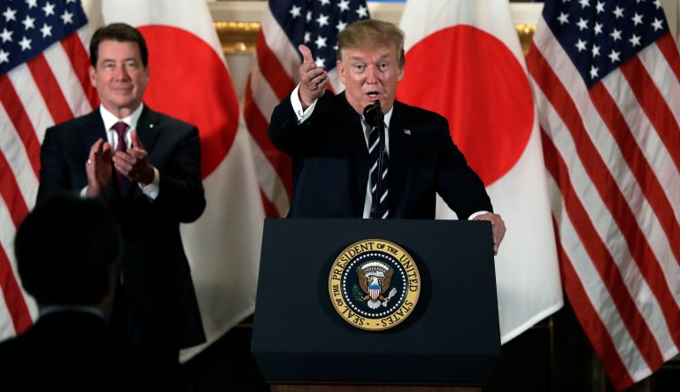 President Donald Trump speaks with Japanese business leaders, Saturday, May 25, 2019, in Tokyo, as U.S. Ambassador to Japan William Hagerty listens.